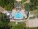 Aerial view of a beautiful community pool with ample seating and surrounding landscaping at 3723 Belle Rose Dr, Leesburg, FL 34748