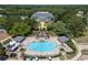 Aerial view of community pool, clubhouse, and lush landscaping creating a resort-style atmosphere at 3723 Belle Rose Dr, Leesburg, FL 34748