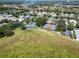 Aerial view of community tennis courts amidst lush greenery and neighborhood homes at 3723 Belle Rose Dr, Leesburg, FL 34748
