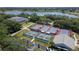Aerial view of multiple tennis courts near a clubhouse, offering ample recreational opportunities at 3723 Belle Rose Dr, Leesburg, FL 34748