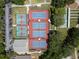 Bird's eye view of community tennis and pickleball courts with neatly maintained landscaping and parking at 3723 Belle Rose Dr, Leesburg, FL 34748