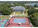 Aerial view of multiple tennis courts near a clubhouse, perfect for active community living at 3723 Belle Rose Dr, Leesburg, FL 34748