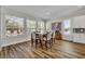 Bright dining room with large windows, hardwood floors, and a stylish dining set at 4060 Longbow Dr, Clermont, FL 34711