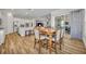 Spacious dining area with hardwood floors and an open view to the kitchen and living room at 4060 Longbow Dr, Clermont, FL 34711
