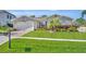 Beautiful single-story home with stone accents, lush landscaping, and a well-manicured lawn at 4060 Longbow Dr, Clermont, FL 34711