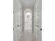 Hallway with marble tile and views into an arched hallway with bathroom at 4060 Longbow Dr, Clermont, FL 34711
