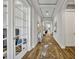 Bright hallway with wood floors, tray ceiling, and archways at 4060 Longbow Dr, Clermont, FL 34711