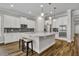 Modern kitchen with white cabinetry, stainless steel appliances, and a large island with seating at 4060 Longbow Dr, Clermont, FL 34711