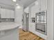 Contemporary kitchen with stainless steel appliances, white cabinetry, and built-in double ovens at 4060 Longbow Dr, Clermont, FL 34711