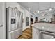 Modern kitchen featuring stainless steel refrigerator, built-in ovens, and a large center island at 4060 Longbow Dr, Clermont, FL 34711