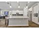 Bright kitchen with white cabinetry, stainless steel appliances, and a large center island at 4060 Longbow Dr, Clermont, FL 34711