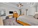 Spacious main bedroom with carpeted floors, tray ceilings, and natural wood furniture at 4060 Longbow Dr, Clermont, FL 34711