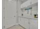 Mud room with white cabinets, countertops, and nautical decor at 4060 Longbow Dr, Clermont, FL 34711