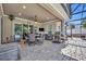 Outdoor living area with covered dining, television, and full kitchen at 4060 Longbow Dr, Clermont, FL 34711