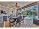 Covered outdoor living area with a full dining set and kitchen at 4060 Longbow Dr, Clermont, FL 34711