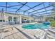Sparkling pool with brick patio, multiple seating areas, and a screened enclosure for outdoor enjoyment at 4060 Longbow Dr, Clermont, FL 34711
