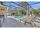 Screened in pool with hot tub and several lounge chairs at 4060 Longbow Dr, Clermont, FL 34711