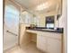 Bathroom showcasing a walk-in shower, large mirror, vanity with storage, and stylish design elements at 4387 Sambourne St, Clermont, FL 34711