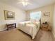 Cozy bedroom with a queen-sized bed, ceiling fan, and carpeted floors for added comfort at 4387 Sambourne St, Clermont, FL 34711
