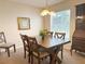Comfortable dining area featuring a wooden table set, neutral walls, and a large window for natural light at 4387 Sambourne St, Clermont, FL 34711