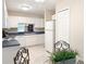 Bright kitchen with white cabinets, countertops, and appliances, offering a clean and functional space at 4387 Sambourne St, Clermont, FL 34711