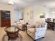 Comfortable living room featuring neutral carpet, and a view of dining room and kitchen through open archways at 4387 Sambourne St, Clermont, FL 34711