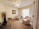 Comfortable living room with seating, carpeted floor, ceiling fan, and a large window for natural light at 4387 Sambourne St, Clermont, FL 34711