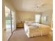 Bedroom featuring a comfortable floral patterned bed, ceiling fan and sliding door leading to a patio area at 4387 Sambourne St, Clermont, FL 34711