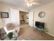 Sitting room featuring neutral decor, comfortable chairs and a view through double doors to the kitchen at 4387 Sambourne St, Clermont, FL 34711