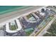 An aerial view shows the location of the beachfront condo complex with community pools and tennis courts at 4841 Saxon Dr # E206, New Smyrna Beach, FL 32169
