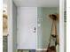 A welcoming entryway features a white door and coastal-themed décor, creating a cozy and inviting atmosphere at 4841 Saxon Dr # E206, New Smyrna Beach, FL 32169
