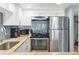 Modern kitchen featuring stainless steel appliances, granite counters, and plenty of storage space for organized cooking at 4841 Saxon Dr # E206, New Smyrna Beach, FL 32169