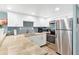 Updated kitchen with granite countertops, subway tile backsplash, and stainless-steel appliances for modern convenience at 4841 Saxon Dr # E206, New Smyrna Beach, FL 32169