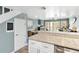 The bright kitchen features granite counters, white cabinets, a breakfast bar, and an open view to the living spaces at 4841 Saxon Dr # E206, New Smyrna Beach, FL 32169
