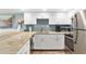 Bright kitchen with granite counters, white cabinets, and stainless-steel appliances, perfect for culinary enthusiasts at 4841 Saxon Dr # E206, New Smyrna Beach, FL 32169