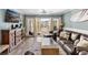 Bright living room with glass doors leading to balcony with pool view at 4841 Saxon Dr # E206, New Smyrna Beach, FL 32169