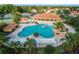 Aerial view of a community pool and recreation center with a large pool, rock features, and tennis courts at 4972 Big Cypress St, Oxford, FL 34484