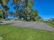Outdoor basketball court with lush green surroundings, mature trees, and well-maintained playing surface at 4972 Big Cypress St, Oxford, FL 34484