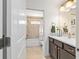 Well lit bathroom with a white shower curtain and vanity with dark wood cabinets at 4972 Big Cypress St, Oxford, FL 34484