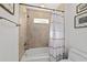 Bathroom featuring a shower/tub combo with tan tiles and a white shower curtain at 4972 Big Cypress St, Oxford, FL 34484