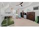 Bedroom with canopy bunk bed, tray ceiling with fan, and custom space themed wall art at 4972 Big Cypress St, Oxford, FL 34484