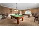 The game room boasts two billiard tables, elegant furnishings, and a warm, inviting atmosphere at 4972 Big Cypress St, Oxford, FL 34484