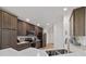 Stylish kitchen featuring dark cabinets, granite countertops, and stainless steel appliances at 4972 Big Cypress St, Oxford, FL 34484
