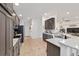 Modern kitchen showcasing dark wood cabinets, granite countertops, and stainless steel appliances at 4972 Big Cypress St, Oxford, FL 34484