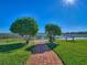 The lake has a brick walkway, inviting bench, picturesque scenery, and a serene atmosphere at 4972 Big Cypress St, Oxford, FL 34484