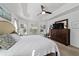 Bright main bedroom featuring neutral decor, tray ceiling, and bay window with natural light at 4972 Big Cypress St, Oxford, FL 34484