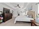 Bright main bedroom featuring neutral decor, tray ceiling, and ensuite bathroom access at 4972 Big Cypress St, Oxford, FL 34484