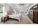 Bright main bedroom featuring neutral decor, tray ceiling, bay window, and a spacious layout at 4972 Big Cypress St, Oxford, FL 34484