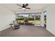 Relaxing screened porch with a chair, fan and great view of the backyard at 4972 Big Cypress St, Oxford, FL 34484