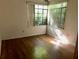 Empty bedroom with wood floors and a large window at 504 S 12Th St, Leesburg, FL 34748